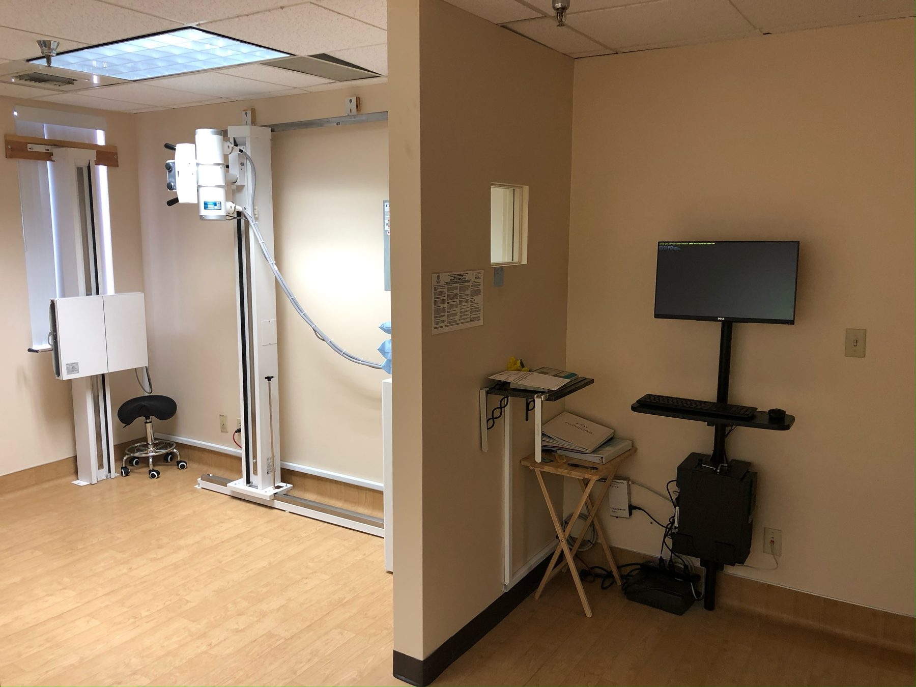 Complete chiropractic digital X-ray room with wall stand, generator, and acquisition station