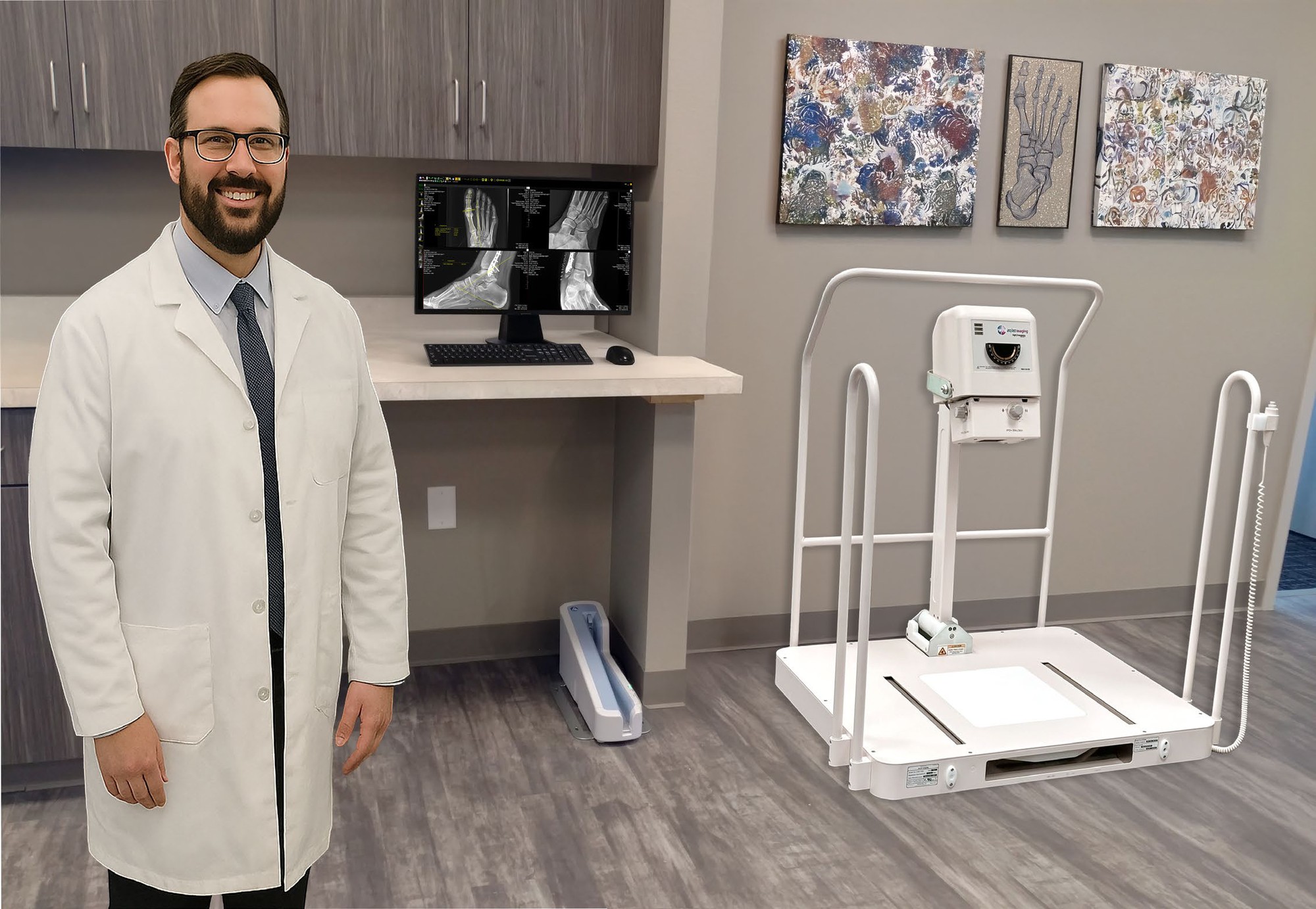 Podiatry exam room with a 20/20 Imaging PXS-710D weight-bearing unit and foot studies on the workstation